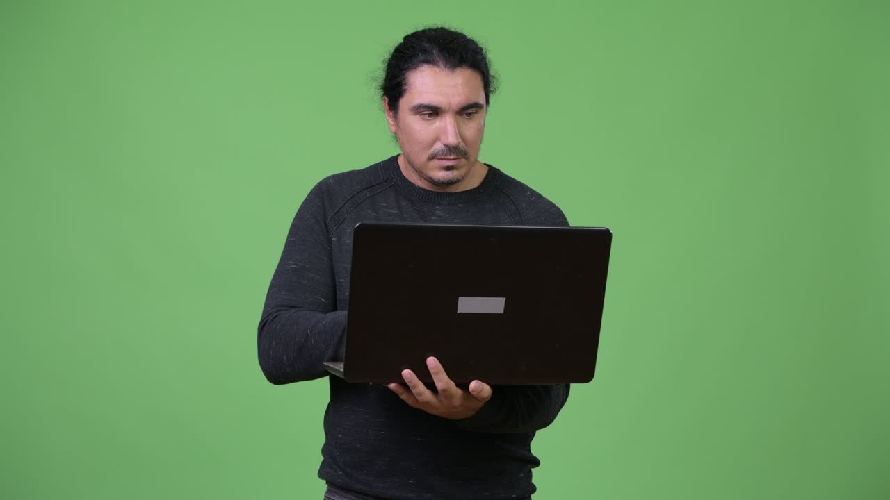 Happy handsome man using laptop