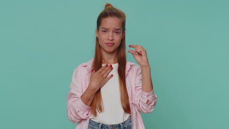 Girl-kid-showing-a-little-bit-gesture-with-sceptic-smile,-showing-minimum-sign,-measuring-small-size