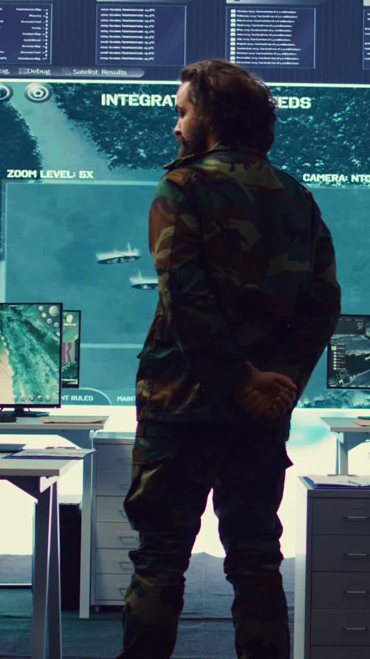 Man in Camouflage Uniform Observing Data on Large Screen