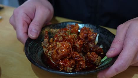 crispy boneless korean fried chicken dish coated with sweet chilli sauce, close up shot of delicious asian food