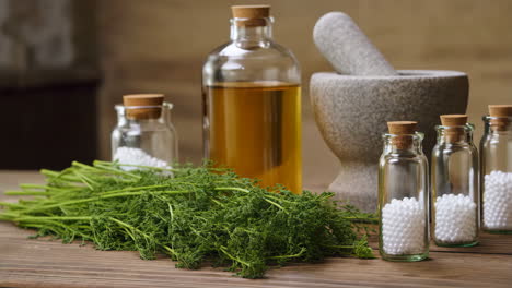 homeopathic remedies and natural herbal medicine ingredients with essential oil and mortar and pestle