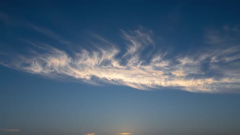 stunning transition of a sunset sky: expansive blue canvas adorned with wispy clouds and soft hues, capturing the essence of evening serenity and natural beauty
