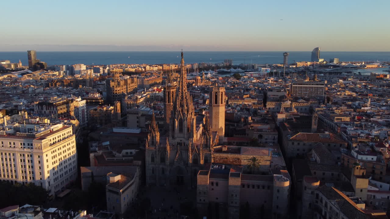 Touristic city of Barcelona at sunset with cathedral focus. Aerial