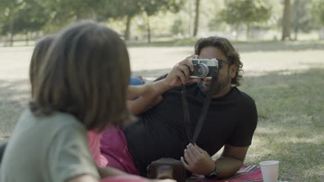 handheld shot of dad with artificial leg photographing his kids