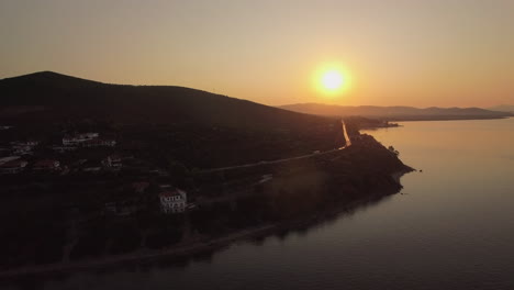 Aerial-view-of-Trikorfo-Beach-coastline-at-sunset-Greece