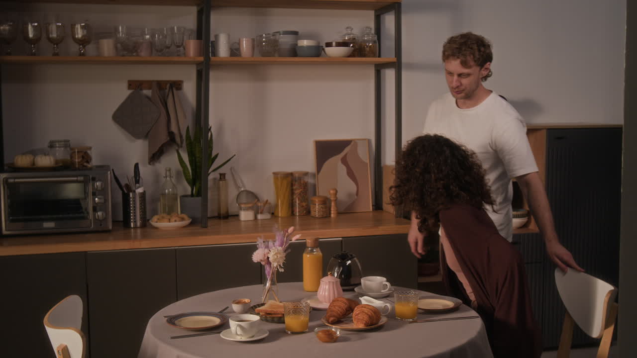 Couple Enjoying Breakfast Together in Kitchen