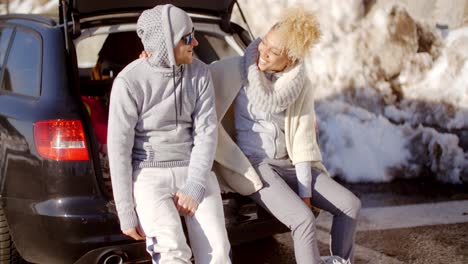 Couple-talking-as-they-put-on-skiing-boots