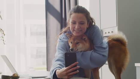 cute girl takes a selfie with her dog at home