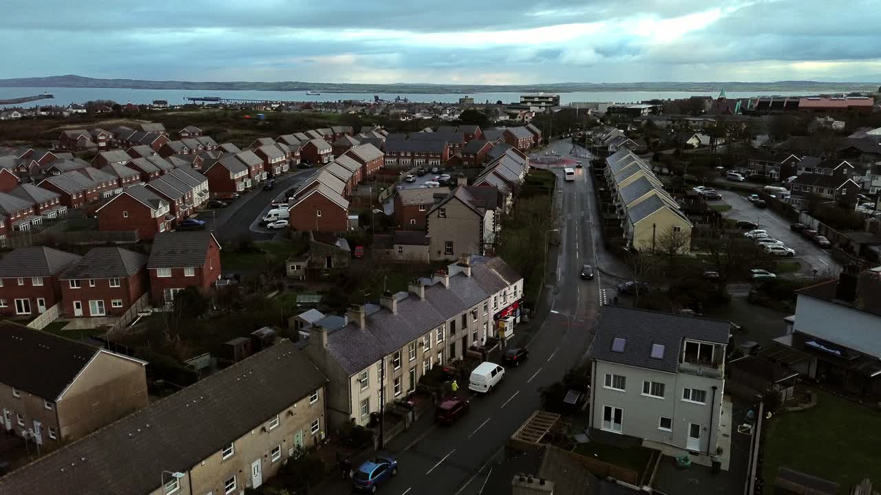 Rainy Holyhead homes aerial rising view over the small Welsh island town neighbourhood real estate