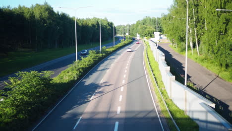 cars driving on a highway in sunny day