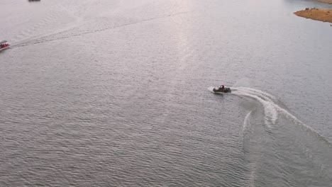 slow-motion of jet ski riding while circling leaving wake on water surface