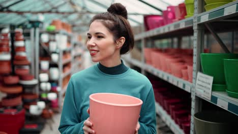 Young-female-customer-chose-clay-flower-pot-for-home-garden-walking-in-floral-department