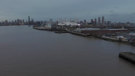 Dolly-back-drone-shot-of-the-O2-over-thames-evening