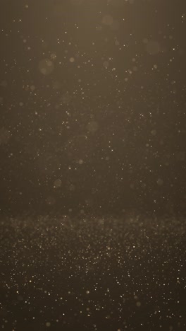 golden dust particles moving gently across dark backdrop creating elegant sparkle effect perfect for