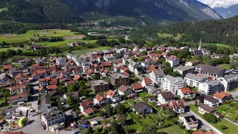 Charming-aerial-view-of-Bonaduz,-Switzerland,-showcasing-a-picturesque-village-and-mountainous-backdrop