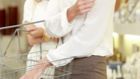 happy blonde selecting beauty product at pharmacy