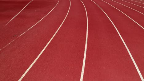 running track at the stadium, color is orange brick, high angle view by drone.