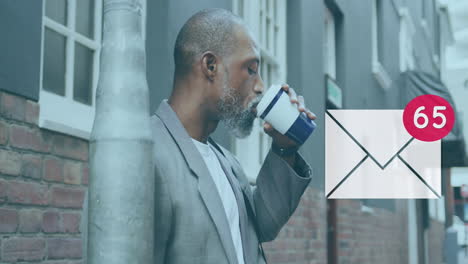 message icon with increasing numbers against african american senior man drinking coffee