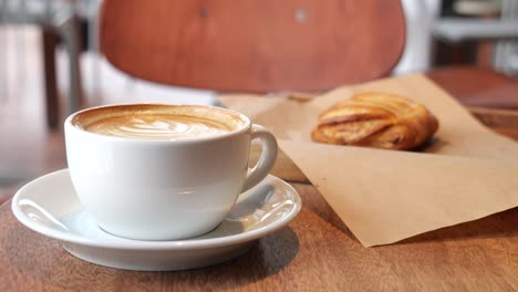 coffee and pastry on a wooden table in a cafe