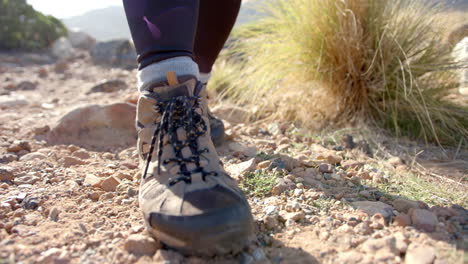 hiking on rocky trail, woman wearing hiking boots and leggings outdoors