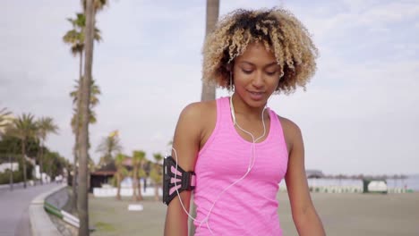 Low-angle-view-of-woman-walking-along-beach