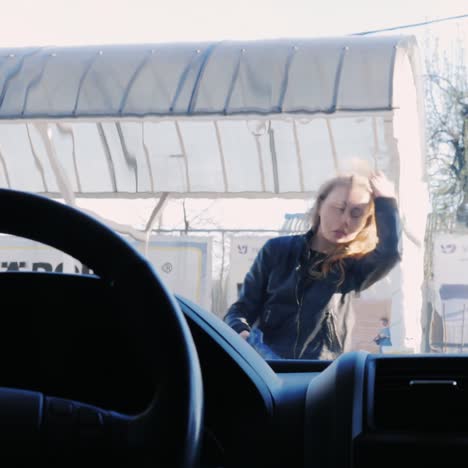 a young woman washes her car in a self-service sink 4