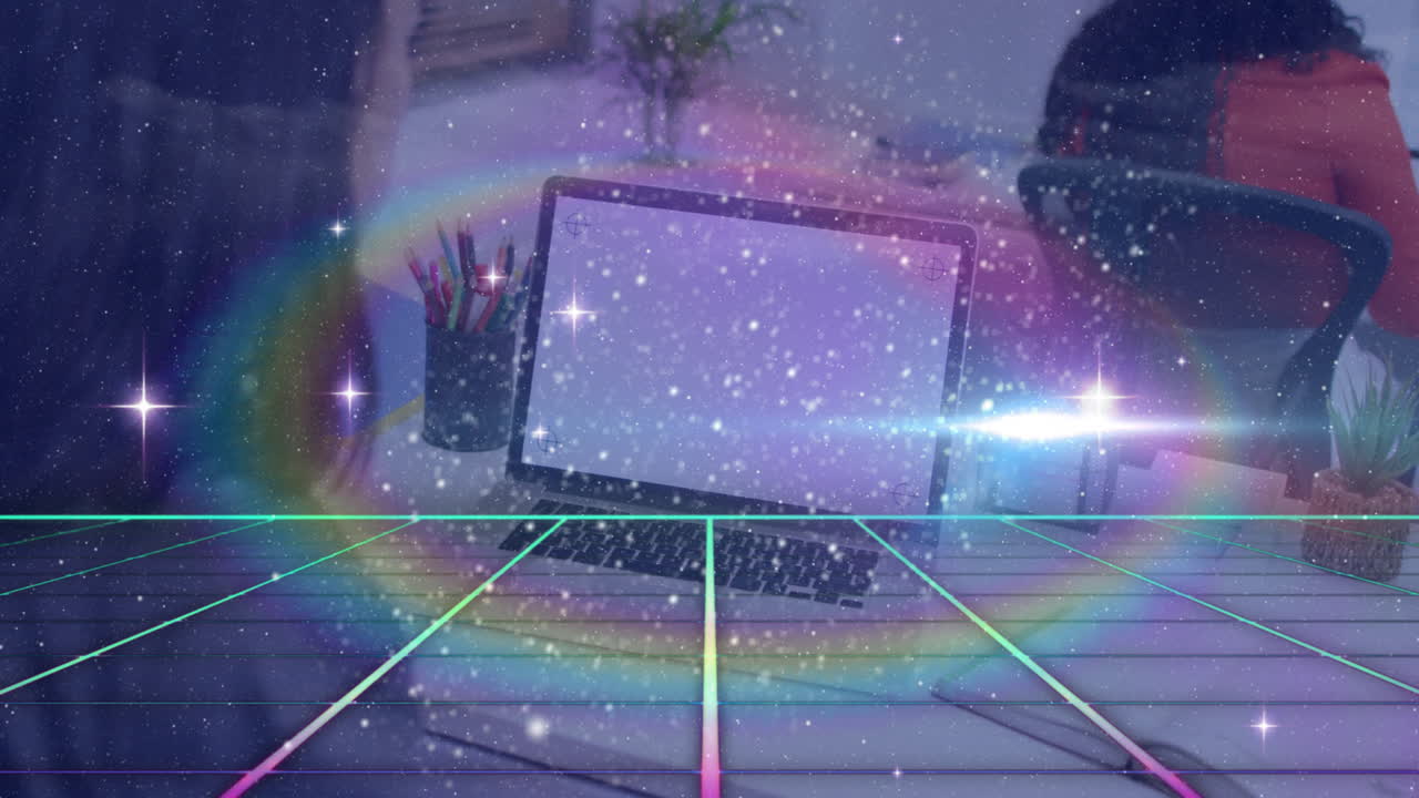 Laptop on desk with rainbow and starry animation overlaying scene