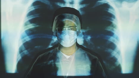 male doctor in protective uniform posing on chest x-ray