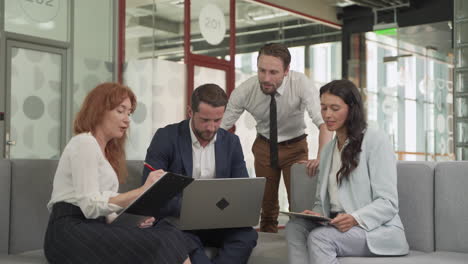 work team composed of two females and two males in a meeting put things in common