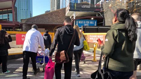 people walking towards market entrance in melbourne