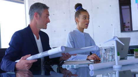 Mult-ethnic business people discussing over blueprint in the conference room at office 4 4k