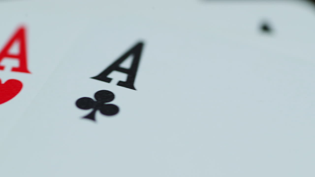 A close up macro shot of playing cards with all four aces hearths diamonds space cross lying on an elephant while moving as the cards slowly expose from the side