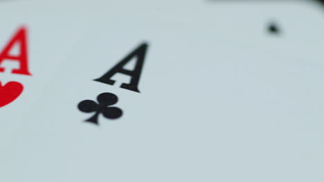 A-close-up-macro-shot-of-playing-cards-with-all-four-aces-hearths-diamonds-space-cross-lying-on-an-elephant-while-moving-as-the-cards-slowly-expose-from-the-side