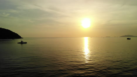 Flight-over-the-ocean-with-golden-sunset-on-the-background