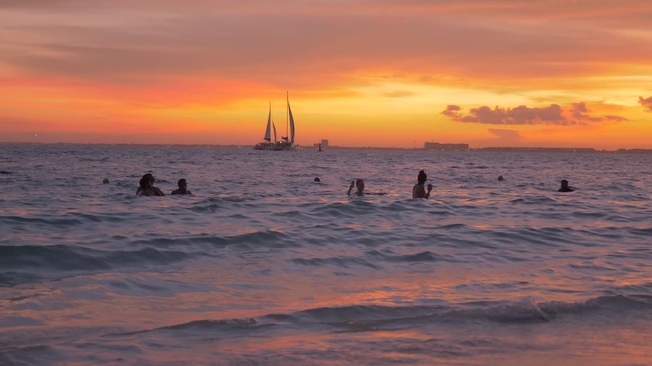 A crowded beach during the golden hour