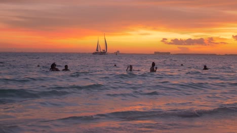 a crowded beach during the golden hour