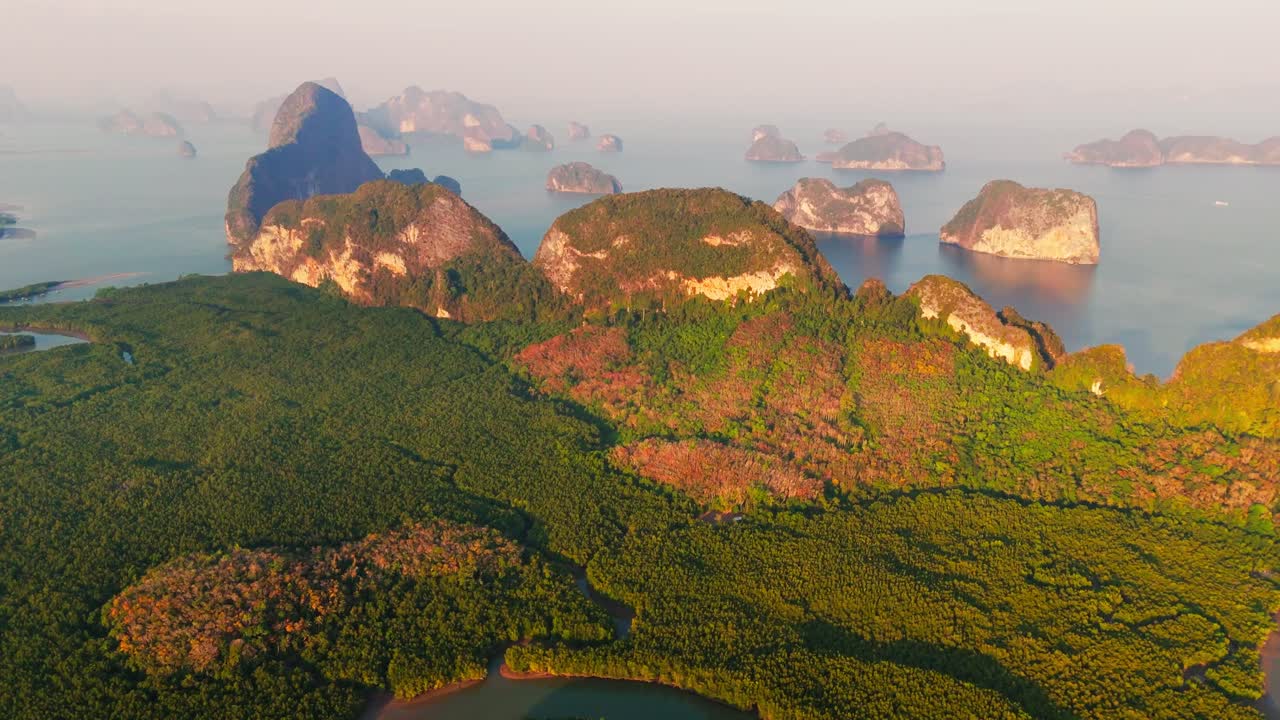 Beautiful morning light on limestone rocks at Phang Nga Bay in Thailand. Drone pullback shot in 4k.