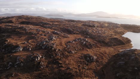 Drone-shot-of-the-peatland,-seascape-and-moorland-landscape-around-Bosta-beach-in-Great-Bernera-looking-towards-Uig-and-the-Isle-of-Harris-in-the-South