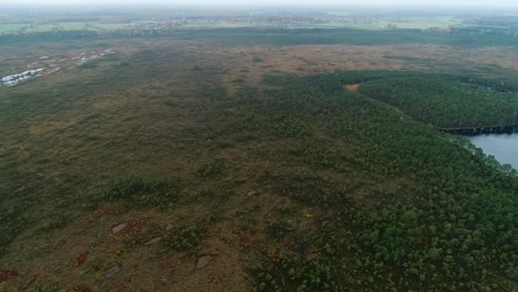 Colorful-seasonal-forests-and-bog-lake-in-autumn-time-aerial-footage