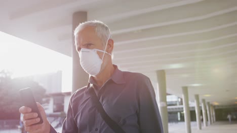 caucasian man out and about in the street wearing on a face mask against coronavirus