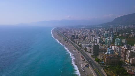 coastal cityscape with turquoise water and mountains