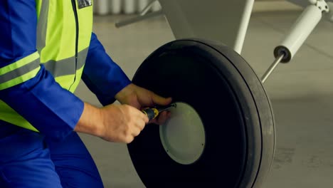 engineer fixing a wheel of aircraft 4k