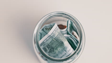 Savings,-cash-and-hands-with-jar-for-home-budget