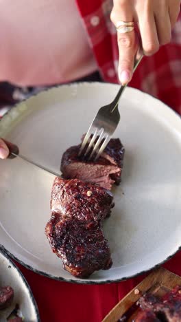 woman eating grilled steak