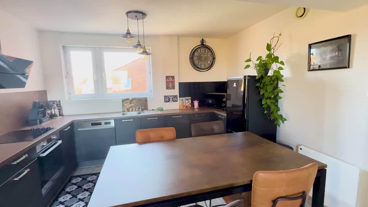 Wide-angle pan reveals bright retro kitchen with vintage decor, modern appliances, and natural daylight