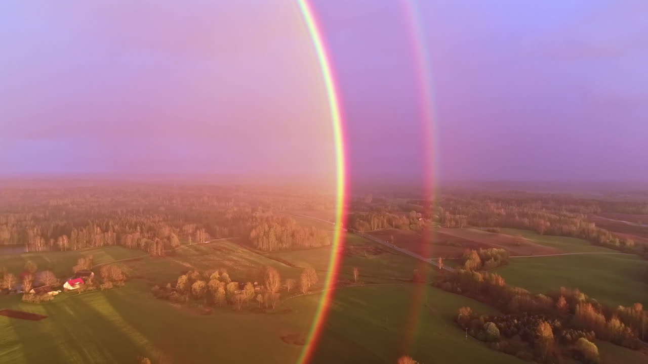 double rainbow sun halo reflection, drone flight over rural landcaspe at daytime