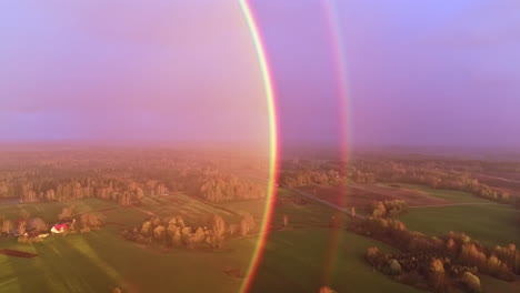 double rainbow sun halo reflection, drone flight over rural landcaspe at daytime