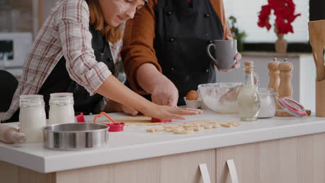 Grandmother-showing-how-to-using-cookies-shape-to-grandchild