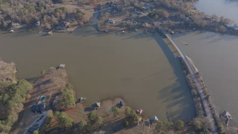 Aerial-footage-capturing-the-rustic-beauty-of-rural-Lincoln,-Alabama,-with-scenic-views-of-lakes,-trees,-houses,-and-expansive-skies