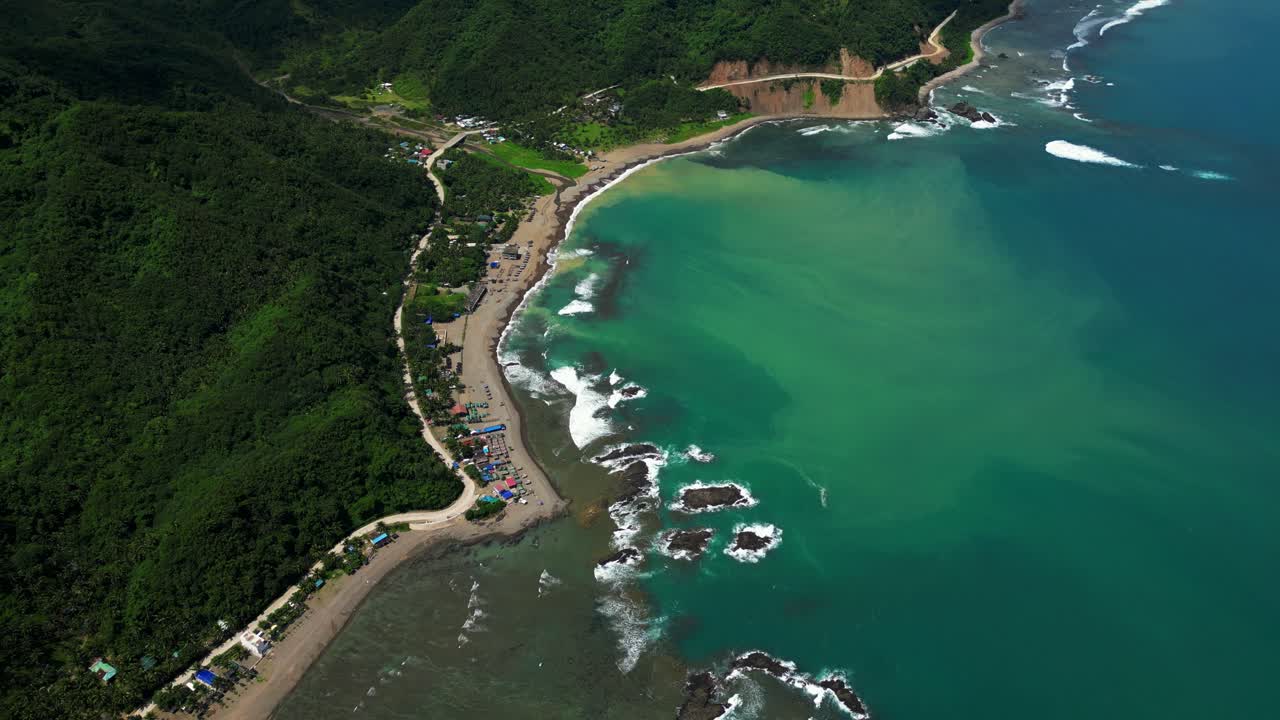 Overhead aerial view of the Matawe Rock Formations in Dingalan, Aurora, showcasing rugged coastal rocks, turquoise waters, and waves crashing dramatically along the shore